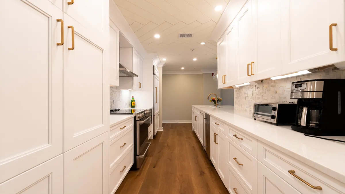 Galley Kitchen Layout Guide: How to Make a Narrow Kitchen Work Bright white galley kitchen with long narrow aisle